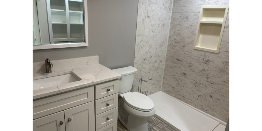 a bathroom with a toilet, sink, and bathtub