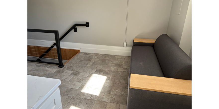 a room with a couch and some stairs