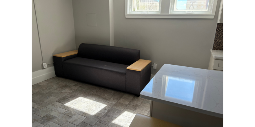 a living room with a couch and a window