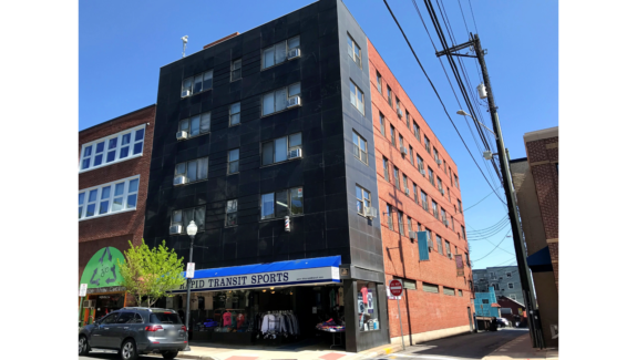 an apartment building on the corner of a street