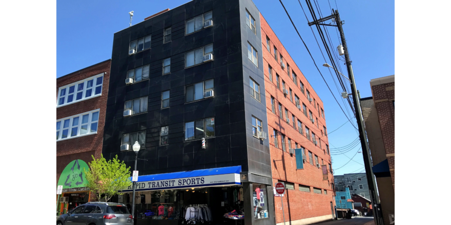 an apartment building on the corner of a street