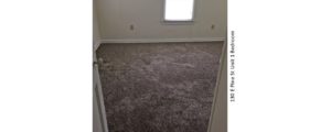 Unfurnished, carpeted bedroom with window