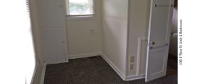 Unfurnished, carpeted bedroom with built in cabinet