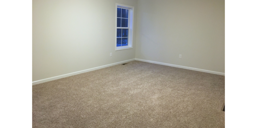 Unfurnished, carpeted bedroom