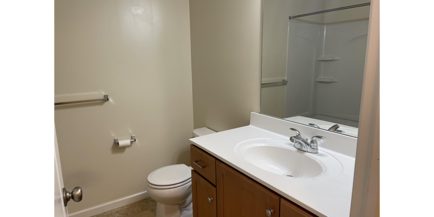 a bathroom with a sink, toilet and shower