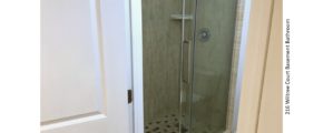 Shower stall with tile and sliding glass door