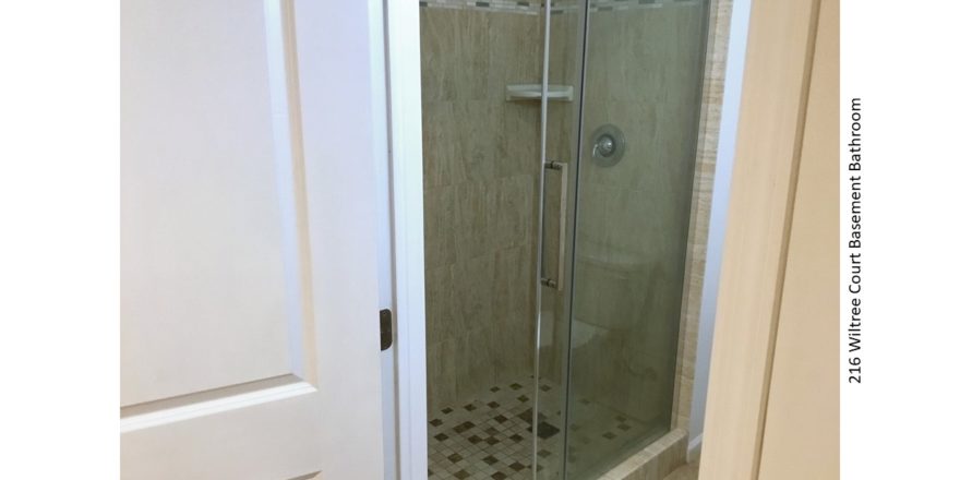 Shower stall with tile and sliding glass door