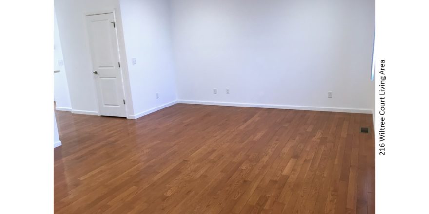 Living area with hardwood floors and window