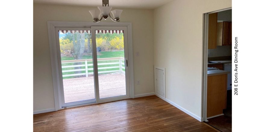 Dining area with hardwood floors, chandelier, and sliding glass door onto back patio