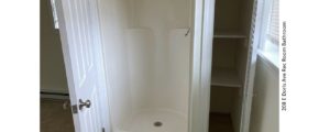 Shower stall with small closet next to it
