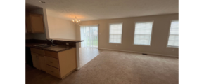 an empty kitchen and living room in an apartment