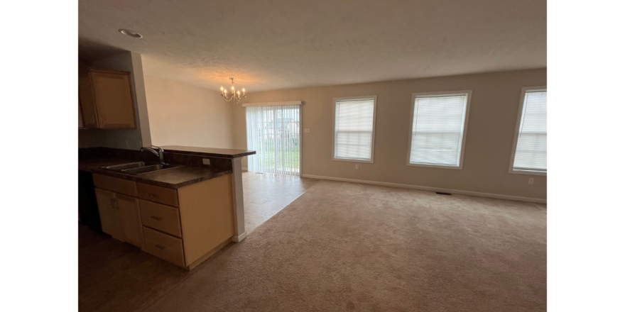 an empty kitchen and living room in an apartment