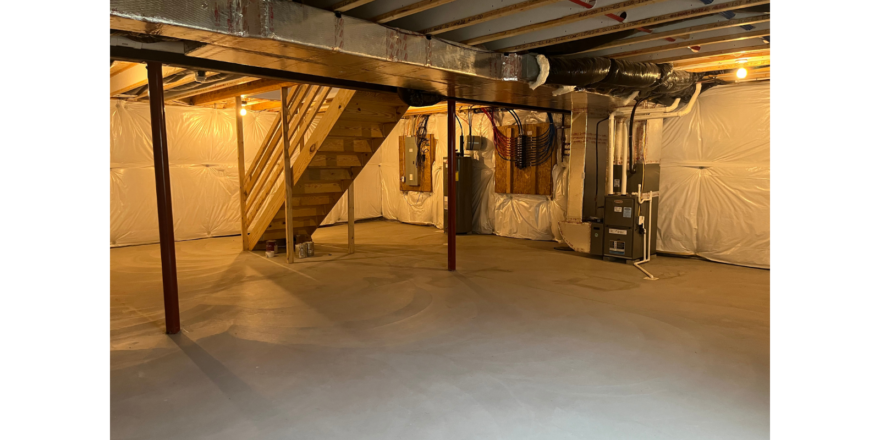 an unfinished room with a staircase and a stove