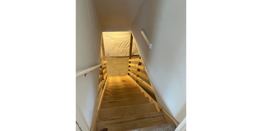 a staircase leading up to the top floor of a house