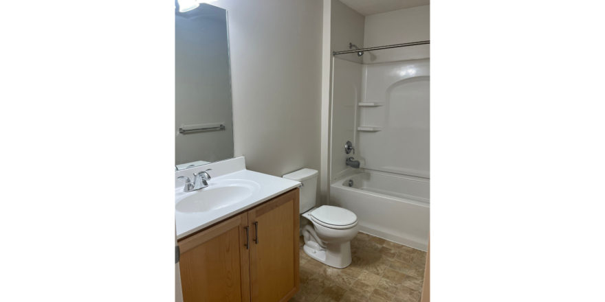 a bathroom with a toilet, sink, and bathtub