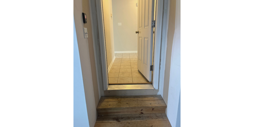 a hallway leading to a bedroom and a bathroom