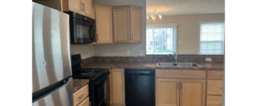 a kitchen with black appliances and wooden cabinets