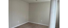 an empty room with a ceiling fan in it