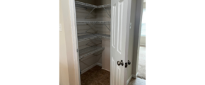 a walk in closet with a white door