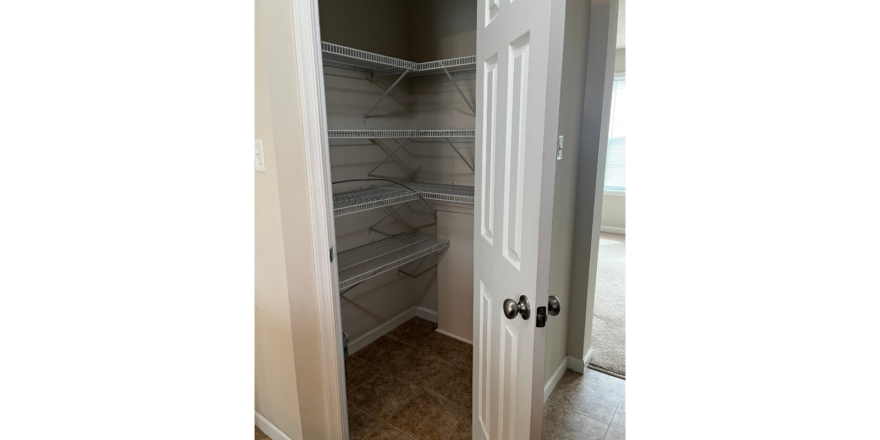 a walk in closet with a white door