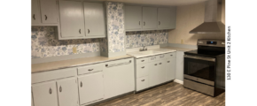 Kitchen with LVP flooring, stainless steel oven, and counter and cabinet space