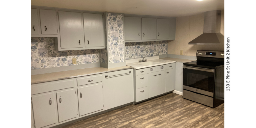 Kitchen with LVP flooring, stainless steel oven, and counter and cabinet space