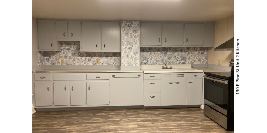 Kitchen with LVP flooring, stainless steel oven, and counter and cabinet space