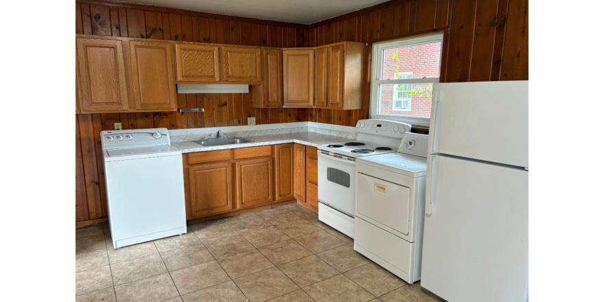 a kitchen with white appliances and wooden cabinets