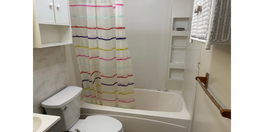 a bathroom with a toilet, sink, and bathtub