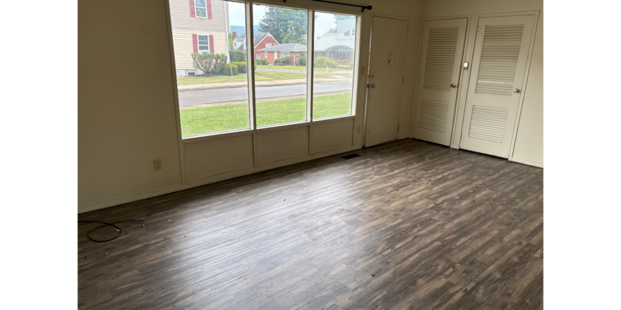 an empty room with a hard wood floor