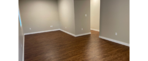 an empty living room with hard wood floors