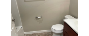 a bathroom with a toilet, sink, and shower
