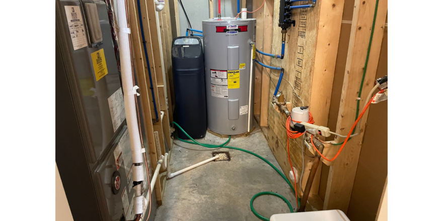 a water heater in a room with a lot of wires