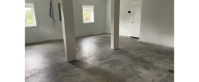 an empty room with white walls and floors
