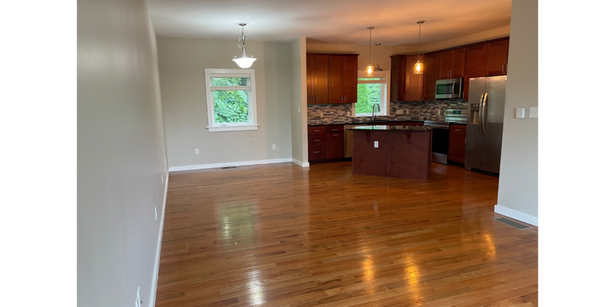 an empty kitchen and living room in a house