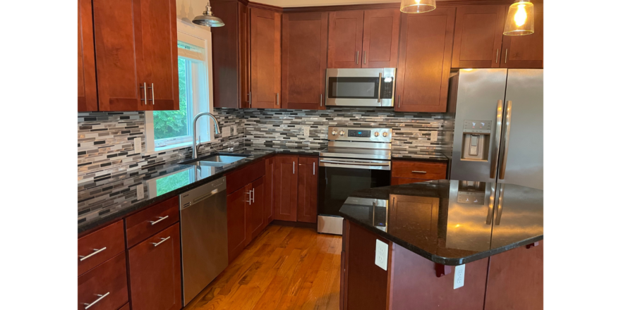 a kitchen with wooden cabinets and stainless steel appliances