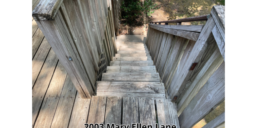 a wooden walkway going up to the top of a hill