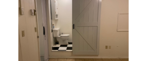 a white bathroom with a black and white checkered floor