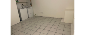 a room with a tile floor and a washer and dryer