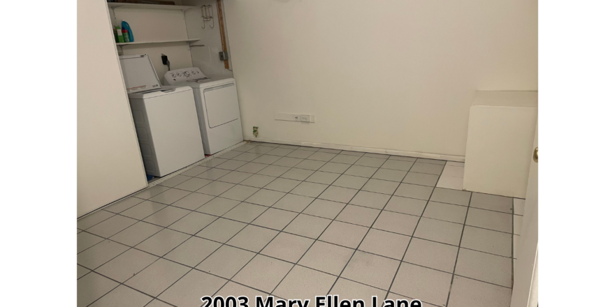 a room with a tile floor and a washer and dryer