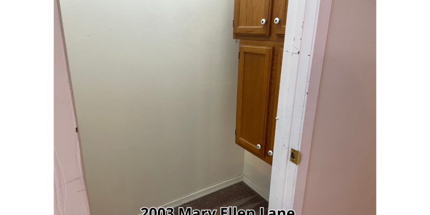 a door is open to a small bathroom