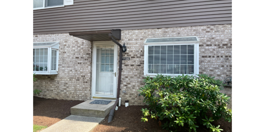 a brick building with a white door and windows