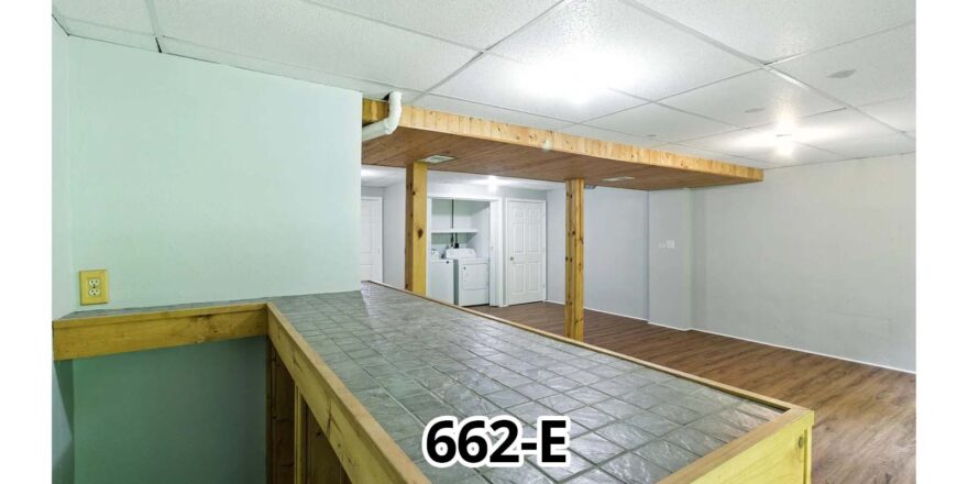 an empty room with wood floors and white walls