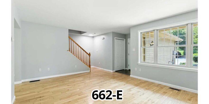 a living room with hard wood floors and a staircase