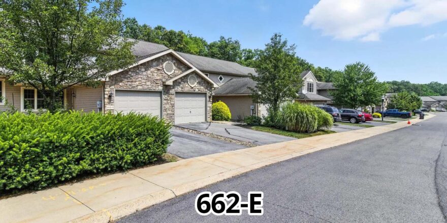 a street with houses and cars parked on the side of it