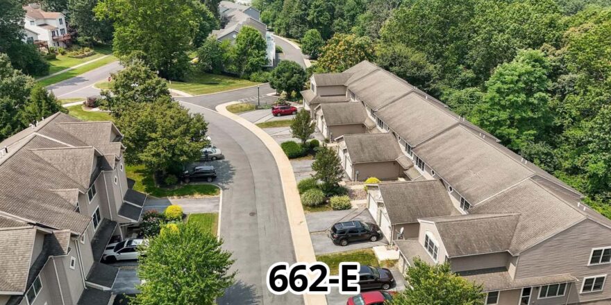 an aerial view of a residential area with cars parked in the driveway