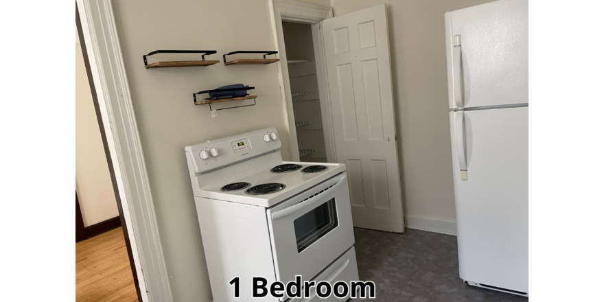 a white stove top oven sitting inside of a kitchen