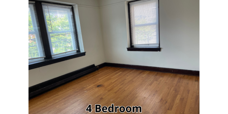 an empty room with three windows and a hard wood floor