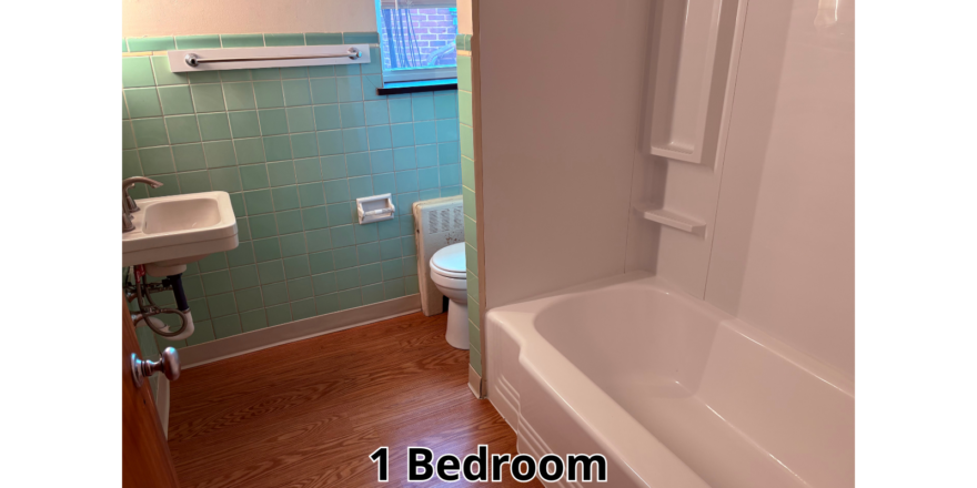 a bathroom with a tub, toilet and sink