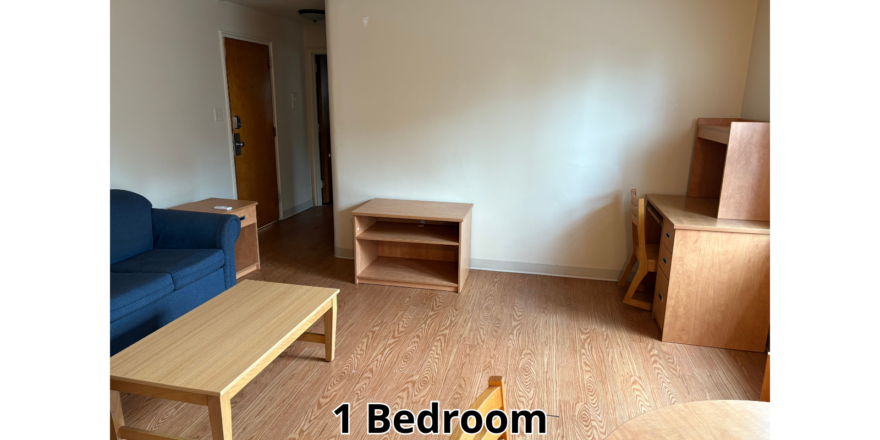 a living room with a blue couch and a wooden table